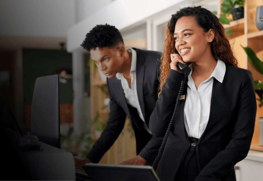 Front desk team delivering consistent guest service supported by standardized hospitality performance across locations