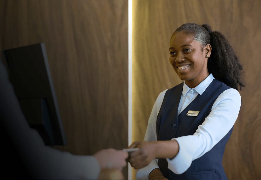 Front desk team member following consistent hospitality service standards across every shift with Typsy