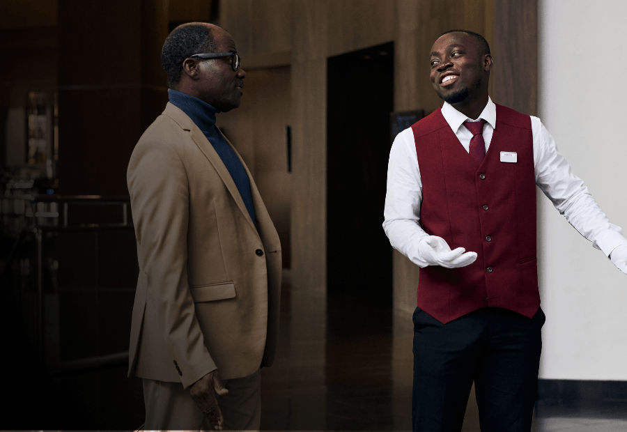 Hotel manager coaching a frontline team member with operational guidance during a shift