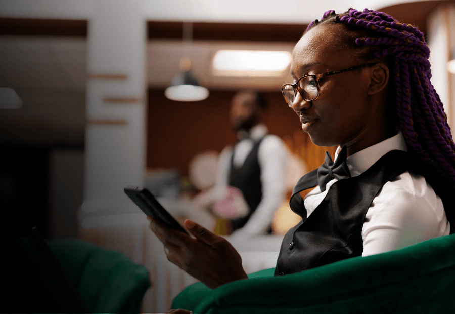Hotel employee accessing Typsy on a mobile device during a shift to support workforce capability in the flow of work
