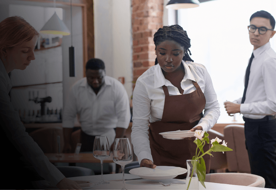 Hospitality team preparing a restaurant for service, representing consistent operational standards supported by expert-led learning