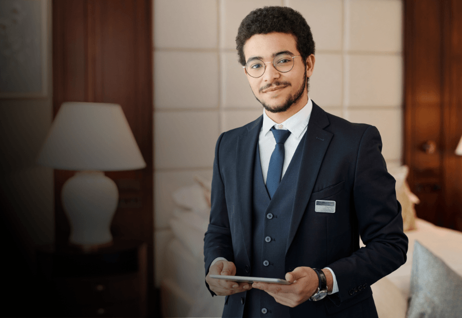 Hotel employee holding a tablet while managing daily operations with mobile workforce capability tools