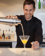 Bartender preparing a cocktail with professional hospitality service standards