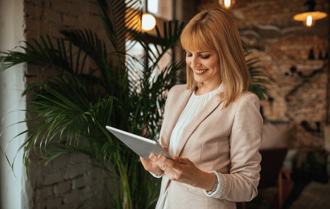 Hospitality manager using a tablet to manage connected systems and operational data through integrated business platforms