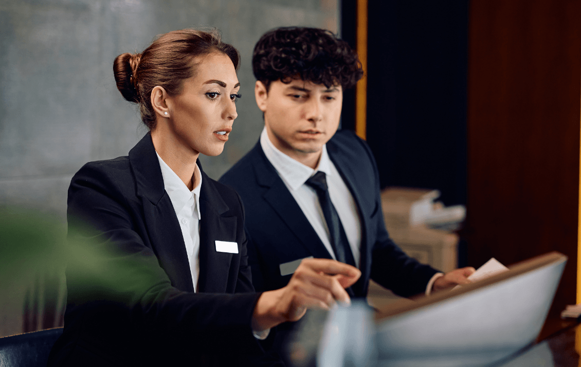 Hospitality manager coaching a front desk team member using operational performance data