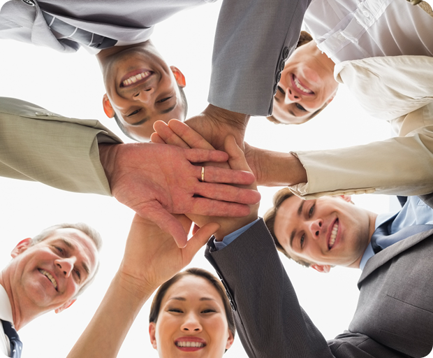 Team members placing their hands together to represent collaboration and partnership